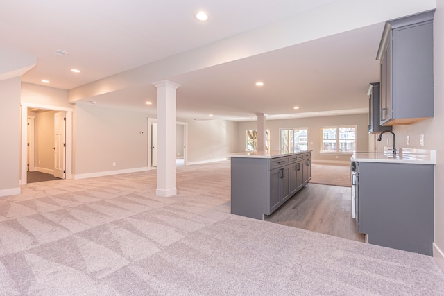 5535 W Huron River Dr, Dexter, MI 48130 - kitchen featuring gray cabinetry, open floor plan, recessed lighting, light countertops, and baseboards