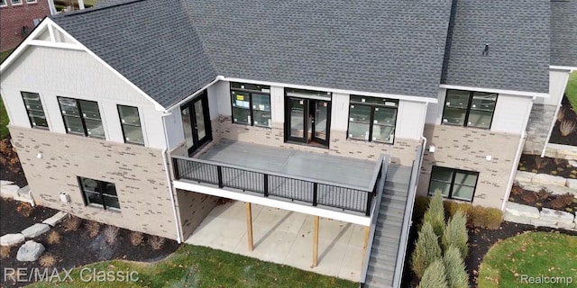 5535 W Huron River Dr, Dexter, MI 48130 - rear view of property featuring a shingled roof and french doors