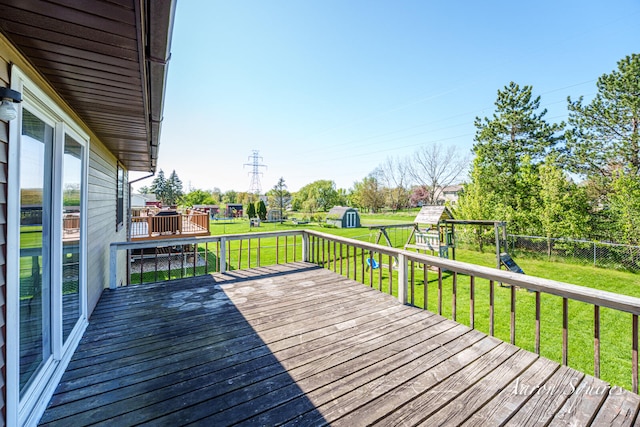 2721 Rum Creek Dr SE, Kentwood, MI 49508 - deck featuring a playground, a storage unit, and an outbuilding