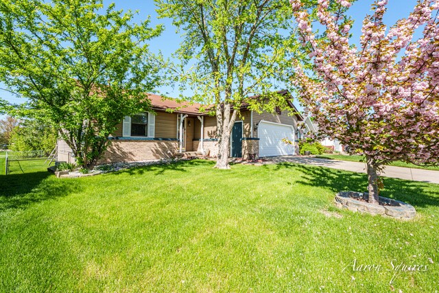 2721 Rum Creek Dr SE, Kentwood, MI 49508 - view of front facade with driveway and an attached garage