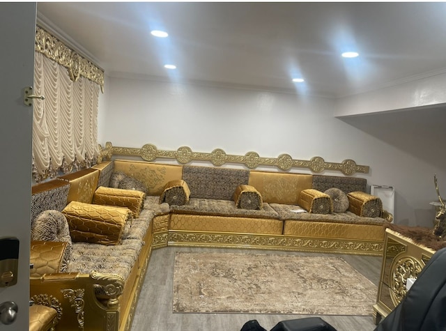 interior space with wood finished floors, ornamental molding, and recessed lighting