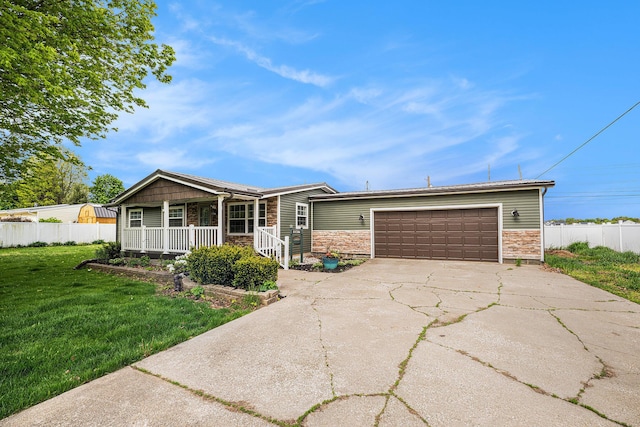 view of front of property with covered porch, stone siding, a garage, and concrete driveway