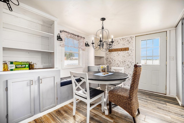 dining room with a chandelier, light wood finished floors, and healthy amount of natural light