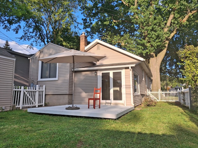 back of house featuring a deck and a chimney