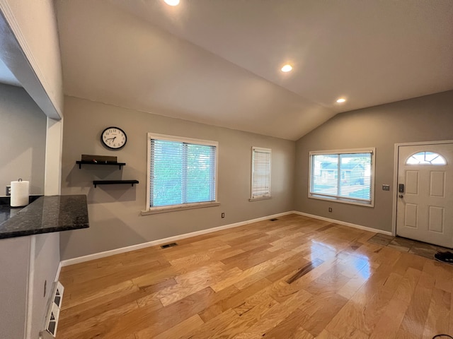 entrance foyer with light wood finished floors, vaulted ceiling, recessed lighting, and baseboards