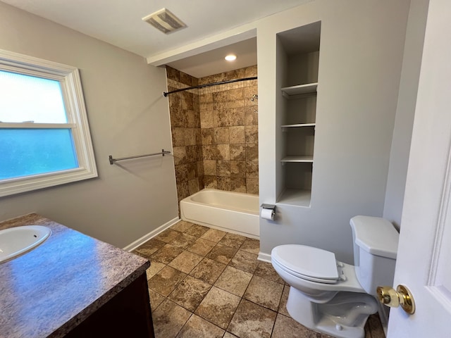 bathroom featuring baseboards, toilet, vanity, and washtub / shower combination