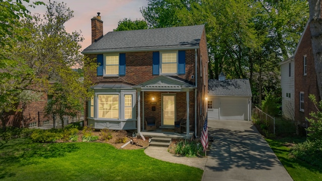 view of front of home featuring a chimney, brick siding, and concrete driveway