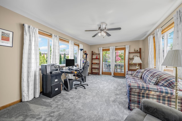 home office featuring carpet flooring, ceiling fan, and baseboards