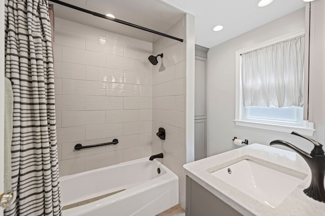 full bath featuring a sink, shower / bathtub combination with curtain, and recessed lighting