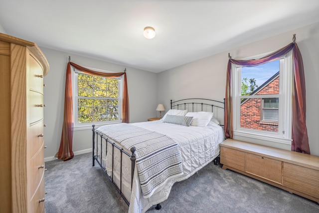 bedroom featuring carpet and baseboards