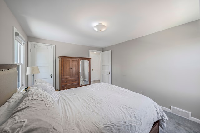 carpeted bedroom with baseboards