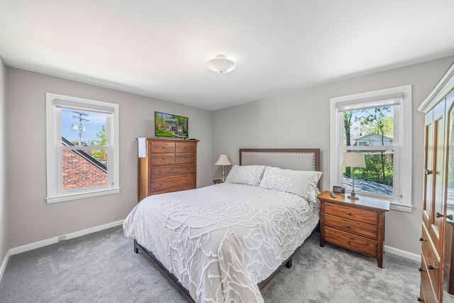 carpeted bedroom featuring baseboards