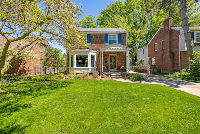 view of front of house featuring brick siding and covered porch