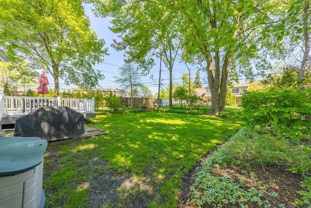 view of grassy yard featuring a wooden deck