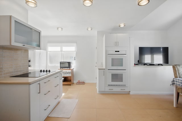 454 Woodland Dr, Saline, MI 48176 - kitchen with white appliances, tasteful backsplash, white cabinetry, light countertops, and baseboards