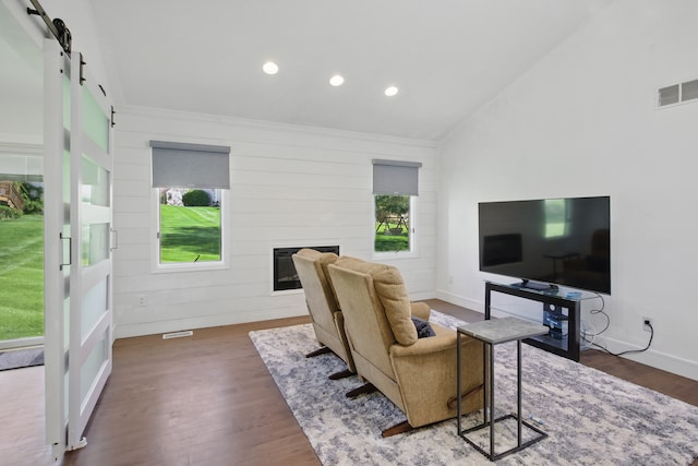 454 Woodland Dr, Saline, MI 48176 - living area featuring a barn door, wood finished floors, recessed lighting, baseboards, and a glass covered fireplace