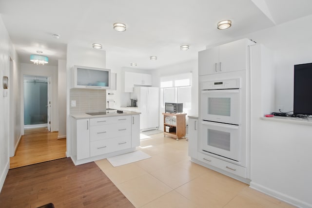 454 Woodland Dr, Saline, MI 48176 - kitchen with white appliances, light countertops, tasteful backsplash, and baseboards