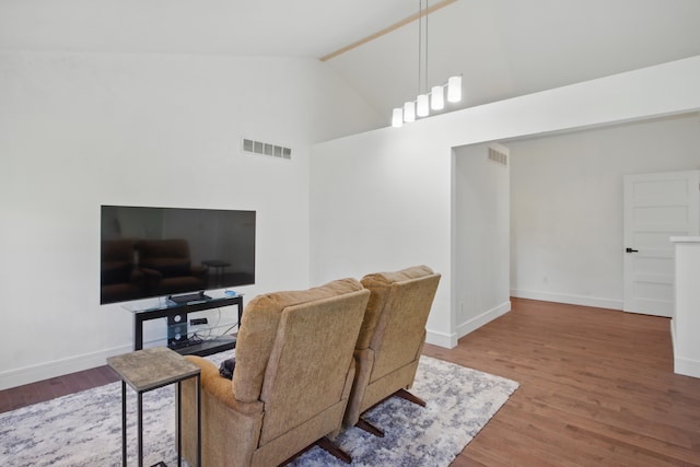 454 Woodland Dr, Saline, MI 48176 - living area featuring wood finished floors, baseboards, and high vaulted ceiling
