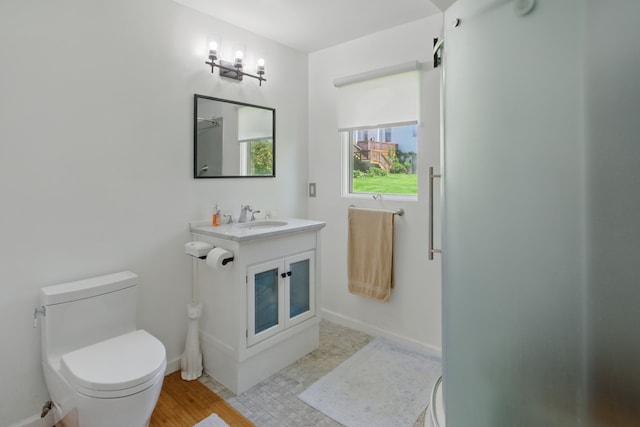 454 Woodland Dr, Saline, MI 48176 - bathroom with toilet, vanity, and baseboards