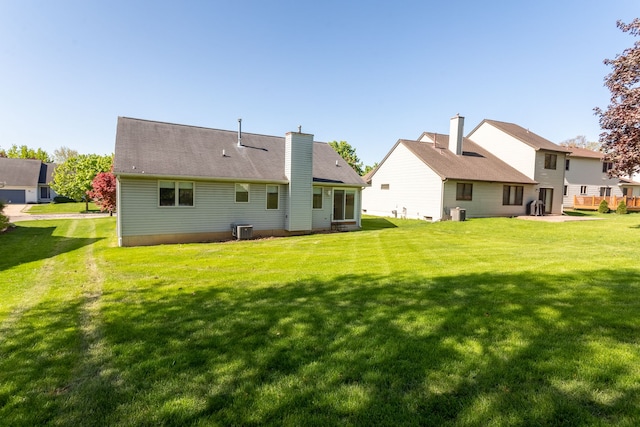 454 Woodland Dr, Saline, MI 48176 - back of house featuring central AC unit and a lawn
