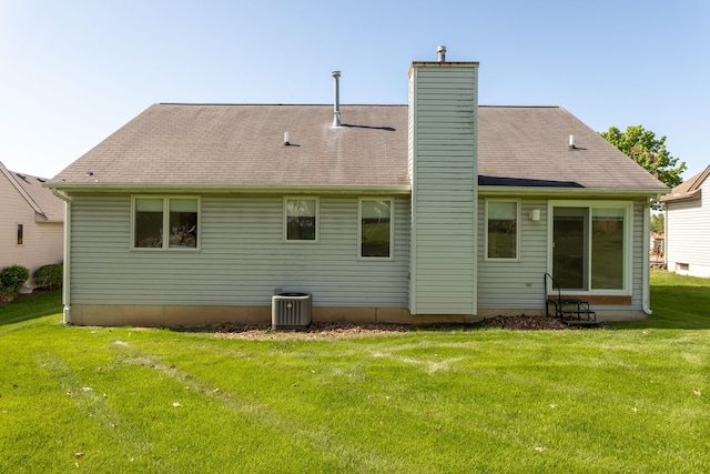 454 Woodland Dr, Saline, MI 48176 - rear view of house featuring central AC unit, a lawn, a chimney, and roof with shingles