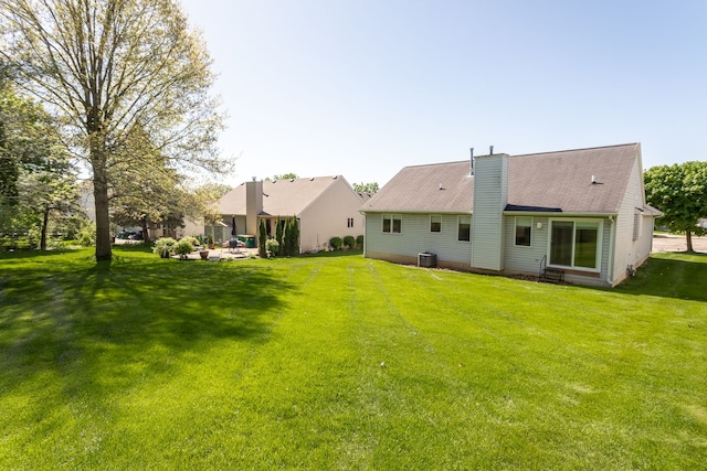 454 Woodland Dr, Saline, MI 48176 - rear view of house with a yard, a chimney, and a patio