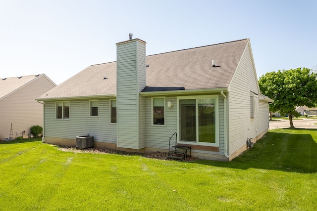 454 Woodland Dr, Saline, MI 48176 - rear view of house with entry steps, central air condition unit, a yard, and a chimney