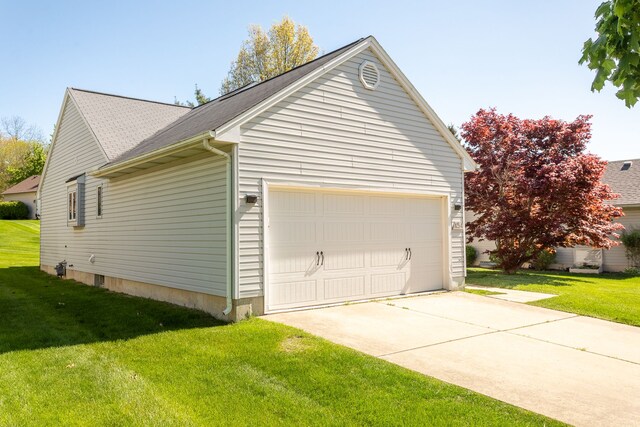 454 Woodland Dr, Saline, MI 48176 - view of side of property featuring a yard, an attached garage, a shingled roof, and concrete driveway