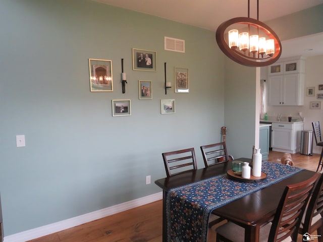 465 Corinth Cir, Dundee, MI 48131 - dining room featuring a chandelier, baseboards, and light wood-style flooring