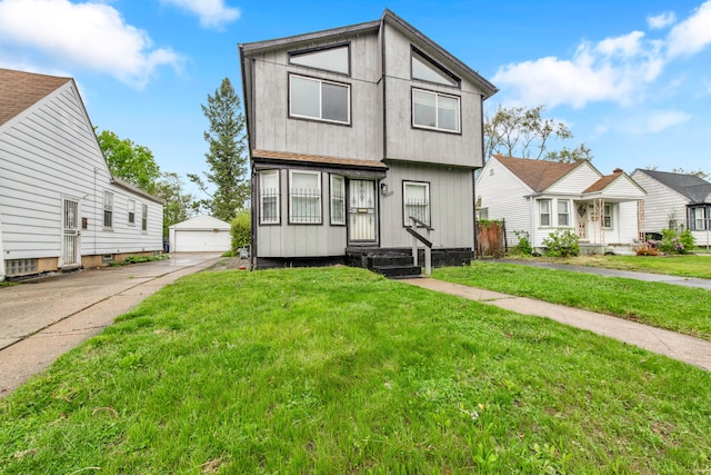 townhome / multi-family property with an outbuilding, a garage, and a front lawn