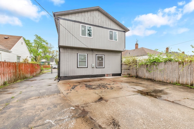 rear view of property with fence
