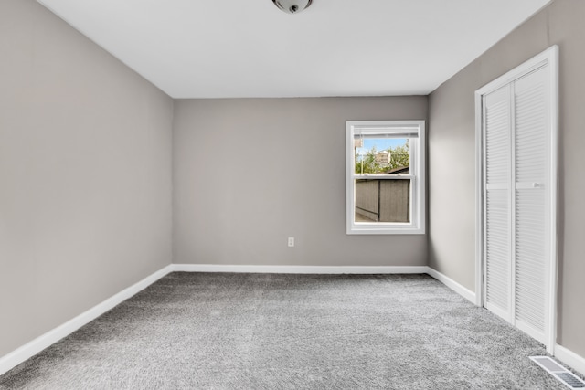unfurnished bedroom with carpet floors, baseboards, and a closet