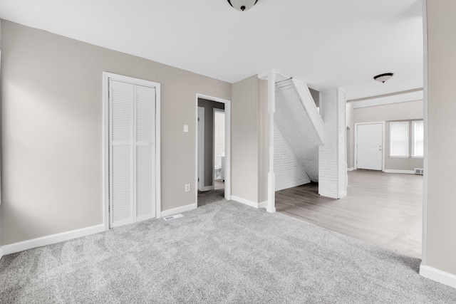 unfurnished bedroom featuring carpet flooring and baseboards