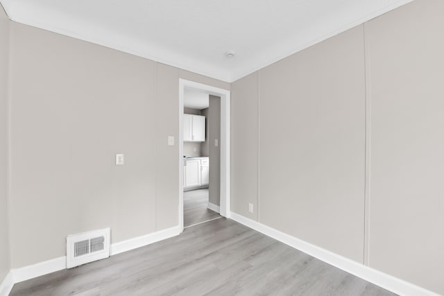 empty room with light wood-type flooring and baseboards