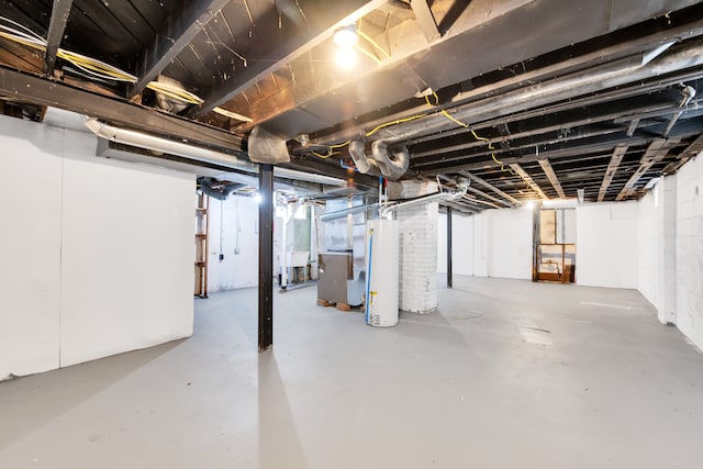 unfinished below grade area featuring water heater