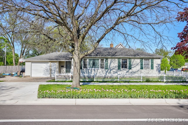 510 Van Raalte Ave, Holland, MI 49423 - ranch-style house featuring an attached garage, concrete driveway, a fenced front yard, and a chimney