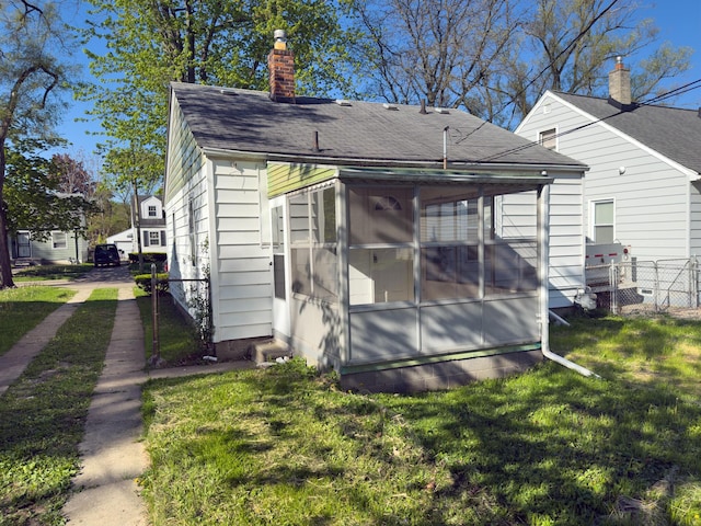 view of outbuilding with a sunroom