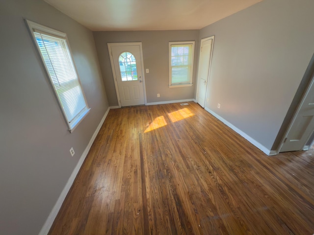 entrance foyer featuring baseboards and wood finished floors