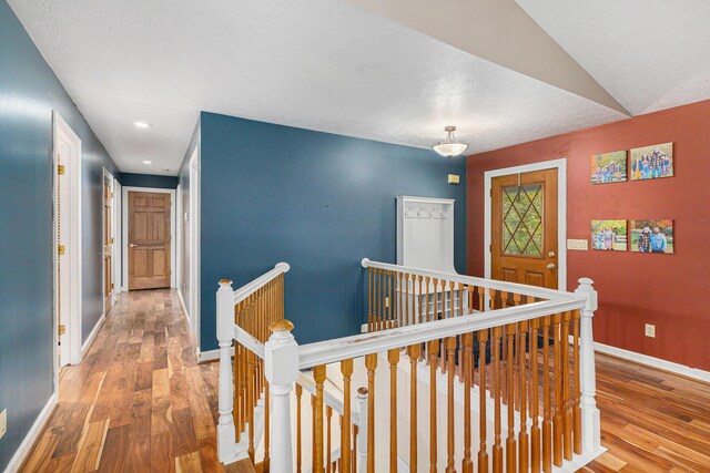 2269 W Liberty Rd, Clarklake, MI 49234 - corridor featuring an upstairs landing, wood finished floors, baseboards, and recessed lighting