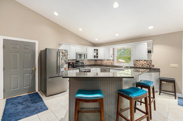 2269 W Liberty Rd, Clarklake, MI 49234 - kitchen with stainless steel appliances, decorative backsplash, a kitchen breakfast bar, light tile patterned floors, and a sink