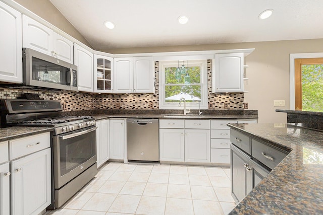 2269 W Liberty Rd, Clarklake, MI 49234 - kitchen featuring appliances with stainless steel finishes, a sink, backsplash, light tile patterned floors, and white cabinetry