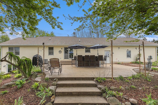 2269 W Liberty Rd, Clarklake, MI 49234 - back of property with a patio area and a shingled roof
