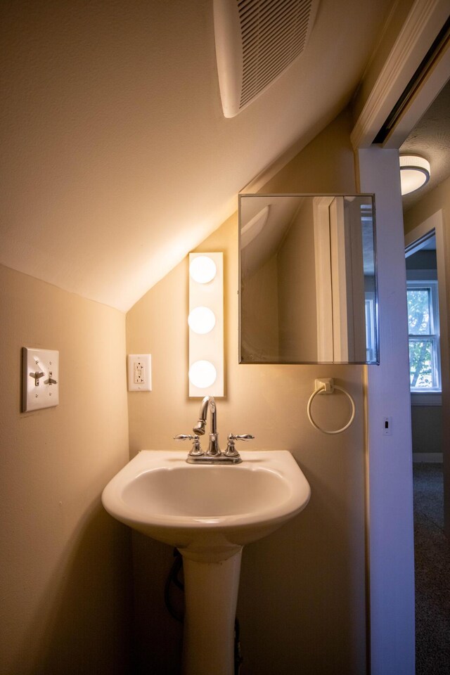 bathroom featuring vaulted ceiling