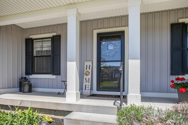 6927 Drumlin Dr, Zeeland, MI 49464 - property entrance with covered porch and board and batten siding