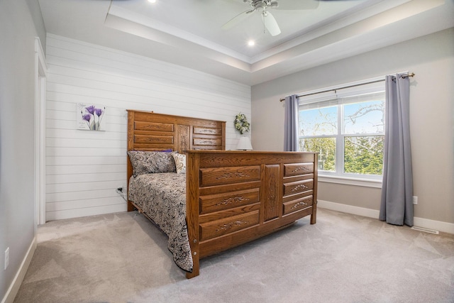 6927 Drumlin Dr, Zeeland, MI 49464 - bedroom with a tray ceiling, light carpet, wooden walls, ceiling fan, and baseboards