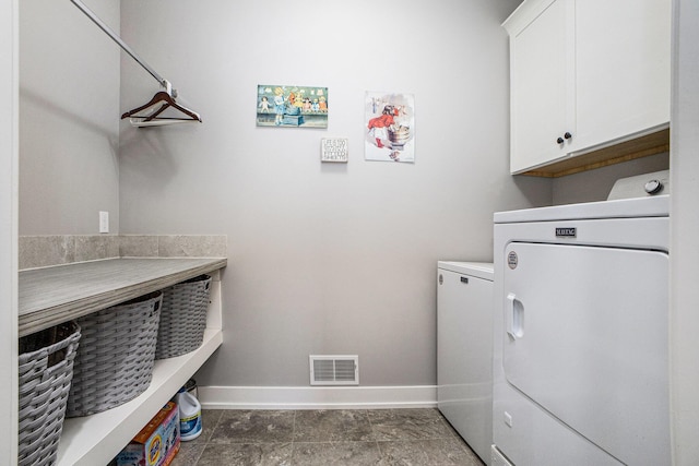 6927 Drumlin Dr, Zeeland, MI 49464 - laundry area with washing machine and clothes dryer, cabinet space, and baseboards