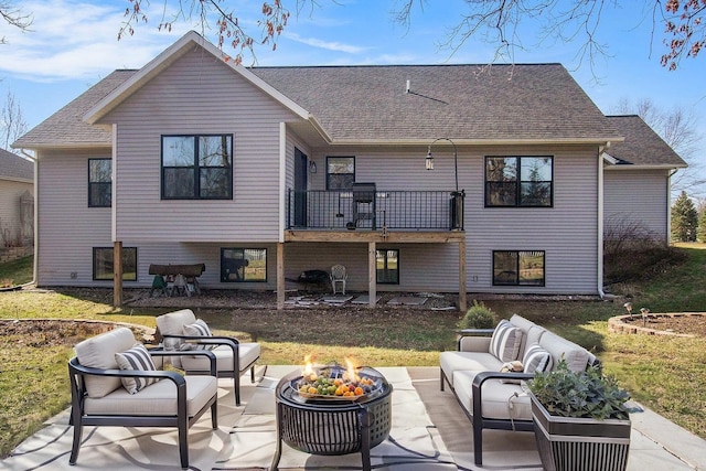 6927 Drumlin Dr, Zeeland, MI 49464 - back of house featuring an outdoor living space with a fire pit, a patio, roof with shingles, and a lawn