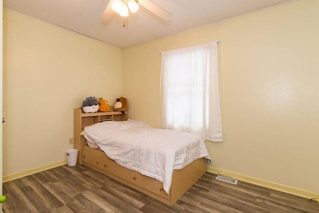bedroom featuring wood finished floors, baseboards, and a ceiling fan