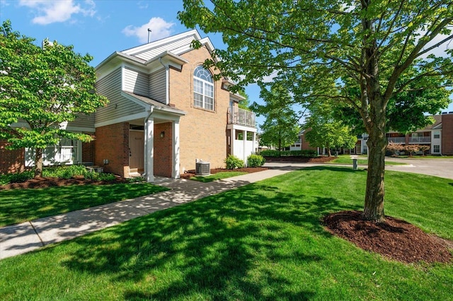 view of home's exterior featuring brick siding and a yard