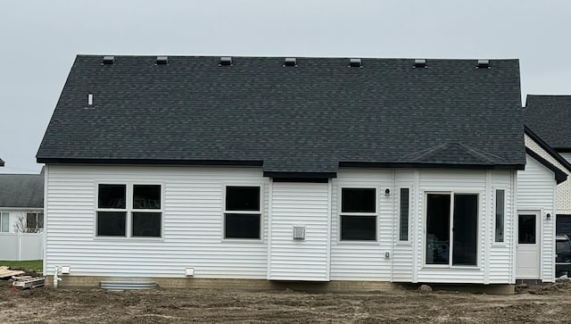 back of property featuring a shingled roof